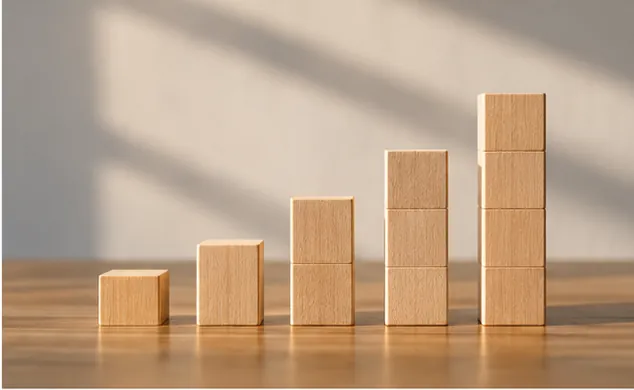 Ascending wooden blocks represent the effect of compound growth